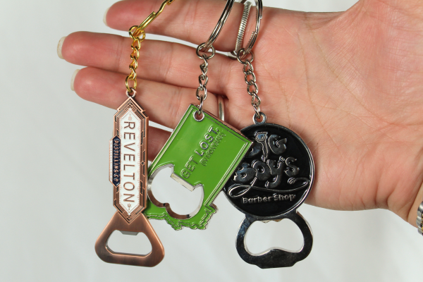 three bottle opener keychains
