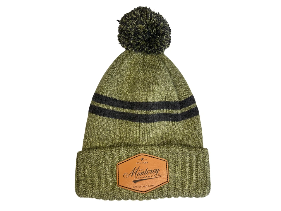 green and black knitted pom beanie with genuine leather patch