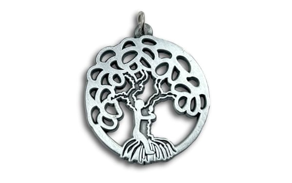 antique silver charm of a figure climbing a tree