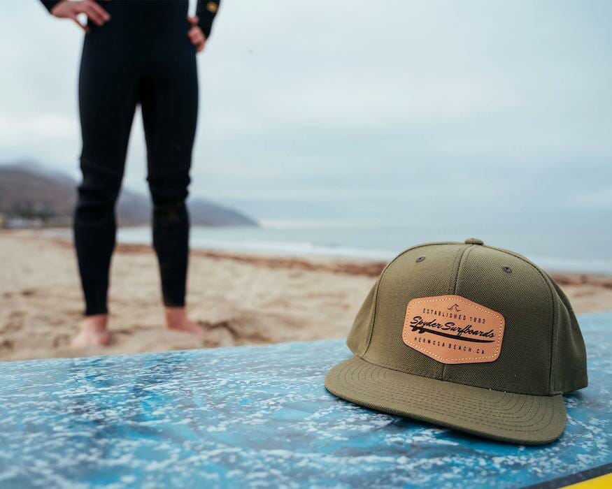 patch hat on surfboard